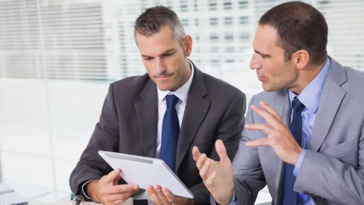 depositphotos_29454873-stock-photo-serious-businessmen-analyzing-documents-on